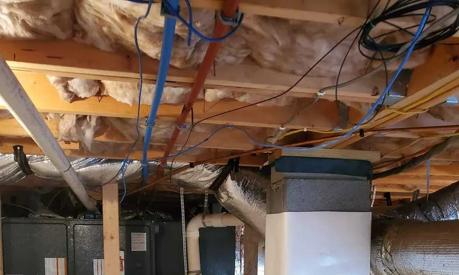An encapsulated crawl space by Rozier Pest Control & Waterproofing with a sealed vapor barrier around the HVAC unit and ducts.