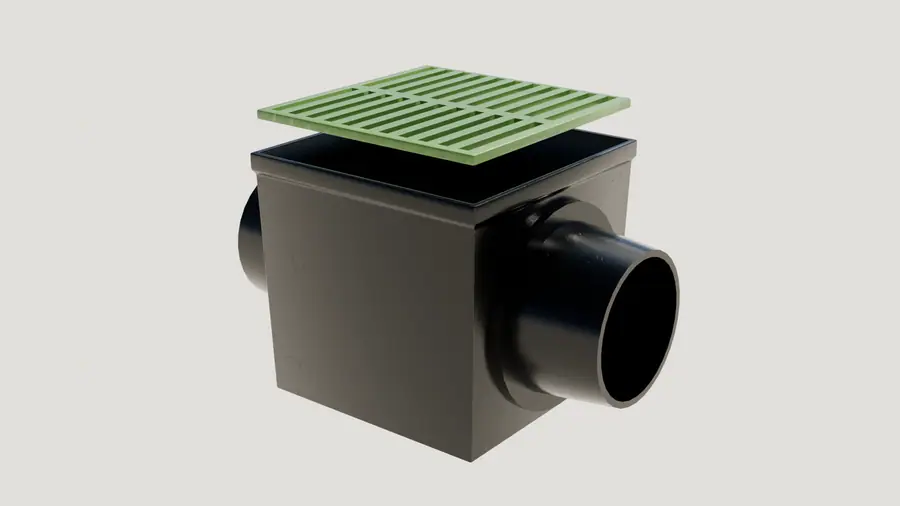Illustration of a black catch basin with two pipe connections and a green drainage grate on top.