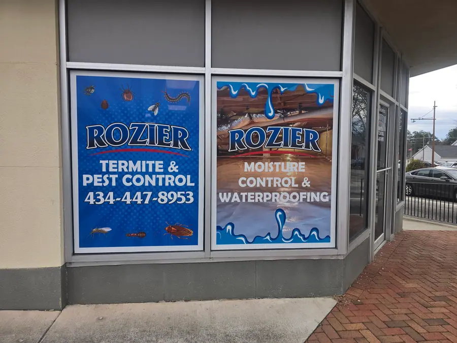 The Rozier Pest Control & Waterproofing office, its windows lettered with the pest control and waterproofing services.
