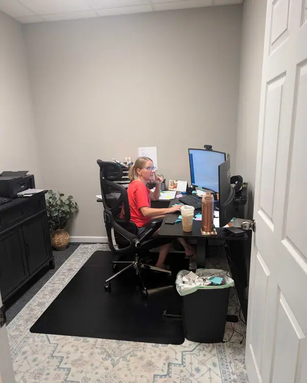A Rozier Pest Control & Waterproofing office team member working at a desk.