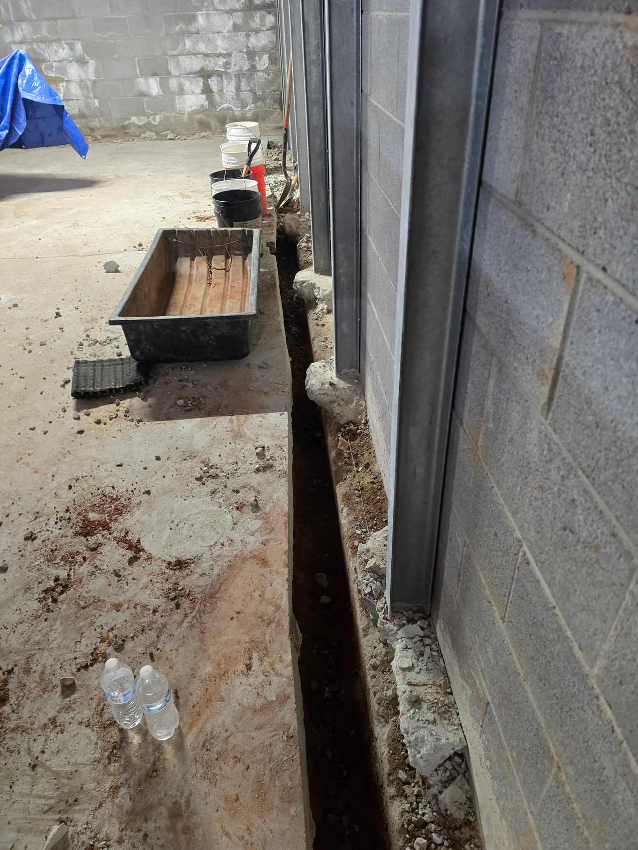 Rozier Pest Control & Waterproofing installing steel I-beam wall bracing for a bowing basement foundation wall.